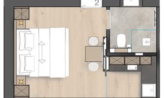 A floor plan of a modern hotel room arrangement. The room features a double bed, a table, and a bathroom.