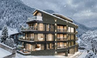 A modern building in a snow-covered landscape. Majestic mountains rise in the background.