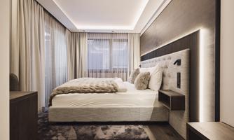 A modern bedroom with a cozy bed and soft colors. Spacious windows let in plenty of light and create an inviting atmosphere.