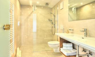 A modern bathroom with a shower and an elegant sink. Bright colors and stylish furnishings create an inviting atmosphere.