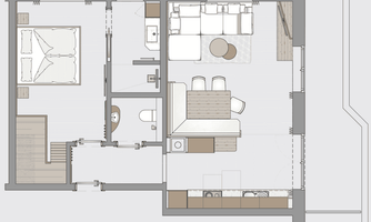 A floor plan of an apartment. It shows two bedrooms, a bathroom, a living area, and a kitchen.