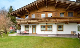 A picturesque wooden house with a spacious garden. The terrace invites you to relax outdoors.
