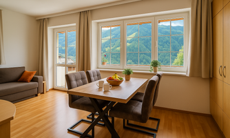 A cozy living space with a dining table and comfortable chairs. Large windows offer a beautiful view of the mountains.