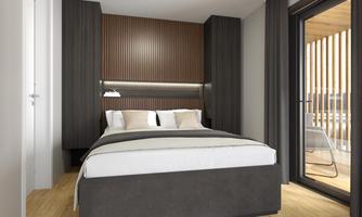 A modern bedroom with a large bed and stylish wooden walls. The room has access to a balcony with French doors.