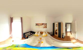 A bright and inviting room with a double bed and cozy pillows. In the background, a sofa and a wardrobe are visible.
