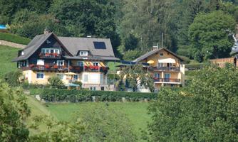 Two beautiful houses in a green landscape. Surrounded by trees and meadows, it is a quiet and idyllic place.