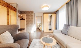 A cozy living room with modern design. Light blue and wood create a pleasant atmosphere.