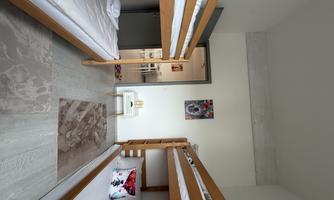 Bedroom with two loft beds and space for up to 4 people.