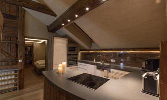 A modern kitchen with wood details and an elegant countertop. The overall picture emanates a cozy atmosphere.