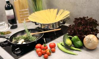A modern kitchen with fresh ingredients.  
Spaghetti, vegetables, and herbs are ready for cooking.