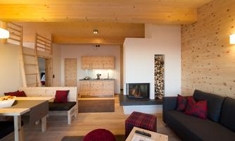 A modern living room with wooden furniture and a cozy fireplace. The room design is bright and friendly, perfect for relaxation.