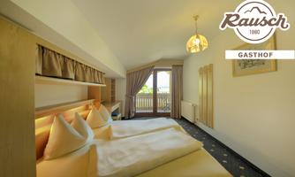 A cozy room with two beds and light furniture. The balcony offers a view of the outdoors and light streams through the window.