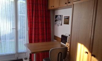 with work table and ironing board, exit to the rear garden