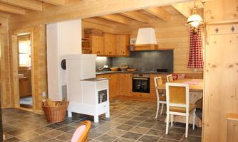 A cozy kitchen with wooden furniture and a modern stove. The room has a rustic charm and invites cooking and lingering.