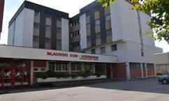 A modern building with an entrance facade displaying "MLADINSKI DOM - YOUTH CENTER". It has multiple floors and a striking architecture.