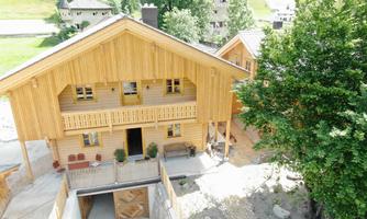 A modern wooden house in a rural setting. Surrounded by trees and gentle hills, it is ideal for a quiet retreat.