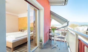A cozy balcony with a view of the surroundings. There is a table and chairs on the balcony, perfect for relaxation.