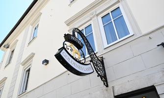 A hotel named "Golden Lamb." The sign is artistically designed and hangs above the entrance.