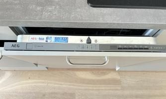 A modern dishwasher from the brand AEG with a unique control panel. The surface is simple and fits well with the kitchen decor.