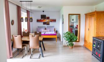 The open space connects the dining table, sleeping area, and cozy corners into a large family room. Ideal for game nights, shared meals, and relaxed hours together.