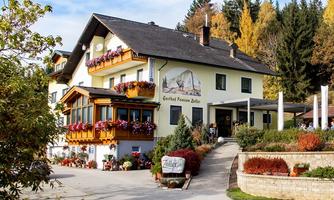 A charming guesthouse with blooming balconies and an inviting atmosphere. Surrounded by trees and beautiful scenery.