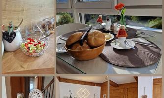 A cozy dining area with fresh bread and a lovely flower decoration. In the background, there is a beautiful view of the mountains.