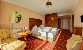 A modern hotel room with a cozy bed and stylish furniture. The decor is bright and welcoming, perfect for a relaxing stay.