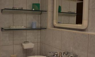 A modern bathroom with a sink and a large mirror. Shelves with decorative objects complement the space.