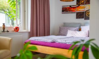 Cozy double bed right by the window with a view of the greenery. Gentle light filters into the room in the morning, perfect for late risers and anyone who loves nature.