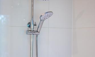 Modern shower faucet with a large shower head and hand shower for a pleasant showering experience. Ideal for recharging after a day at the lake or in the mountains.