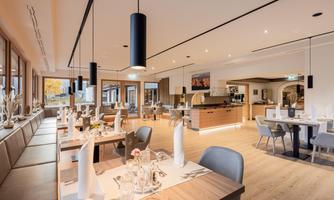 A modern restaurant with stylishly set tables. Bright colors and an inviting atmosphere ensure comfort.