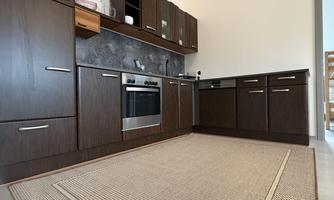 Detailed kitchen view with many cabinets for space and storage.
