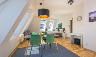 A modern apartment with a dining area and a cozy bedroom. Large windows provide plenty of light and a friendly atmosphere.