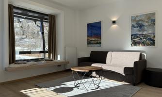 A modern living room with a cozy sofa and a round coffee table. Large windows provide a view of the nature outside.