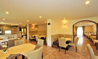 A bright and modern restaurant with cozy tables and chairs. The decor is friendly and welcoming.