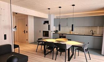 A modern kitchen with a dining area. Bright wooden floors and stylish furniture create an inviting atmosphere.