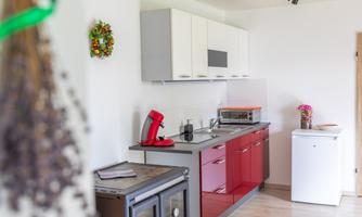 Fully equipped kitchenette with sink, stove, oven, and coffee machine. Here, families can cook peacefully, snack, and eat together at the table.