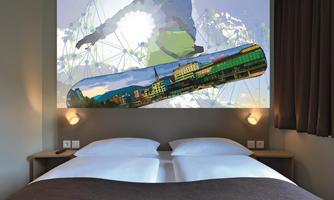 A modern bedroom with a double bed and a striking wall design that depicts a skateboard scene. The room has a bright, inviting atmosphere.