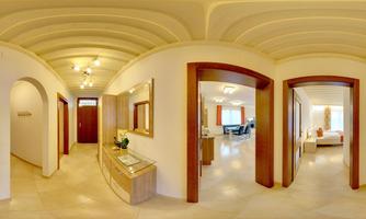 A bright hallway with cream-colored walls and an ivy-like ceiling. Various doors lead to additional rooms, including a mobile furnished living area.