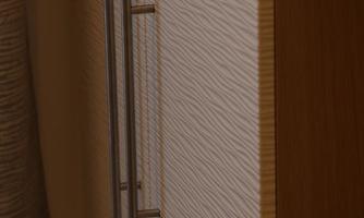 A modern piece of furniture with a textured surface and a silver handle. The wooden frame is designed to be light and welcoming.