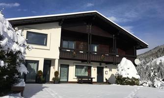 A beautiful house in a snow-covered landscape. The surroundings are calm and picturesque.