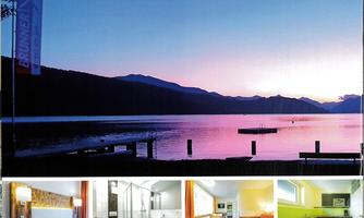 A peaceful lake landscape at sunset with gentle mountains in the background. Below are images of cozy rooms and a modern bathroom.