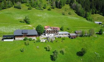 A picturesque building amidst green meadows and forests. The surroundings are calm and idyllic.