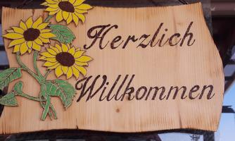 A wooden sign with the inscription "Warm Welcome" and decorated with sunflowers. It conveys a warm and inviting atmosphere.