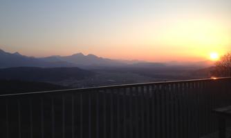 A breathtaking sunset over the mountains. The landscape is illuminated in warm colors.