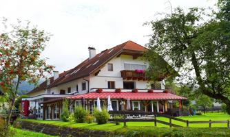 A charming hotel in a rural setting with a large garden. The facade is cheerfully designed, and the terrace invites you to linger.