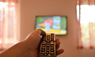 A hand is holding a remote control in front of a television. A colorful animation is displayed on the screen.