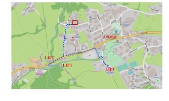 A map that shows a city plan with marked paths and lift locations. The route to the spa area is marked by a blue line.