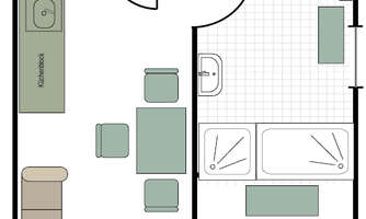 A floor plan of an apartment with two bedrooms, a living area, and a kitchen. The balcony is also marked.