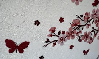A wall decoration with red butterflies and blooming cherry blossoms. The colors are vibrant and give the room a fresh atmosphere.